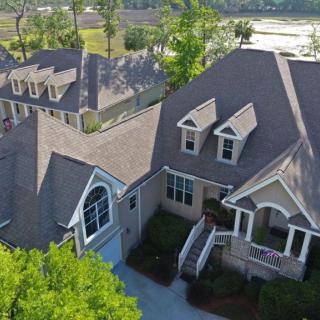 Aerial view of a residential house surrounded by trees.