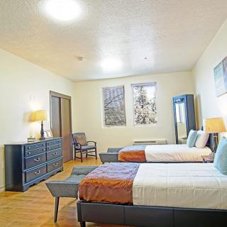 A spacious bedroom with twin beds, modern decor, and elegant furniture.
