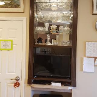 A stylish cabinet displaying decorative items and a television beneath.