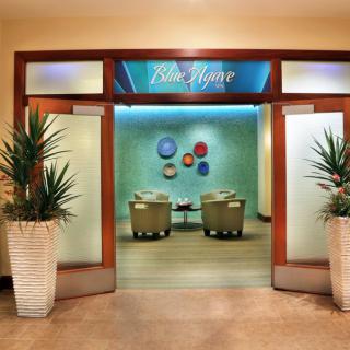 Entrance to a relaxing spa lobby with seating and decorative elements.
