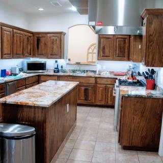A spacious modern kitchen with wooden cabinets and a central island.