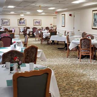 An elegant dining area with neatly arranged tables and chairs, ready for guests.