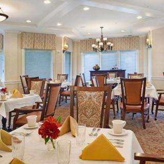 A well-arranged dining room with elegant table settings and comfortable seating.