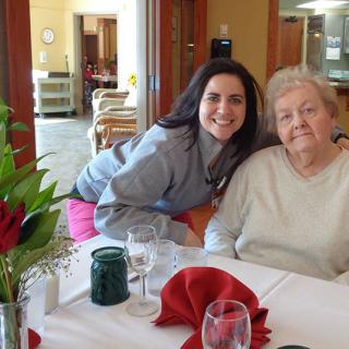 Two people posing at a restaurant table with elegant table settings.