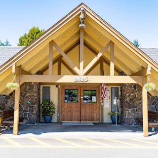 A welcoming entrance featuring a blend of wooden and stone architecture.