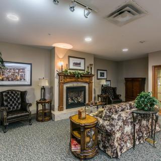 A cozy living room with a fireplace, seating area, and elegant decor.