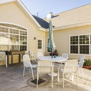 A cozy outdoor patio with seating, perfect for enjoying sunny days.