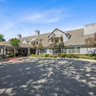 A large residential building with a well-maintained exterior and a spacious driveway.