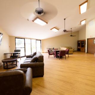 A spacious and modern living area with ample natural light and contemporary furnishings.