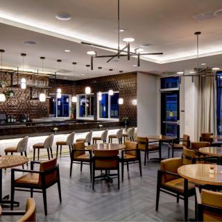 Modern restaurant interior with a bar and seating area.