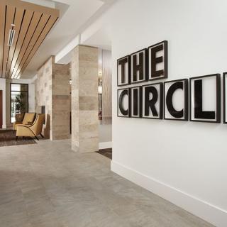 Modern lobby with decorative wall sign and stylish furniture.