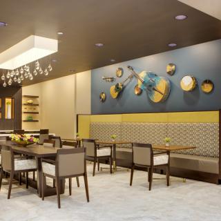 Modern restaurant interior with artistic wall decor and seating.