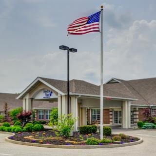 An exterior view of a building with an American flag prominently displayed.