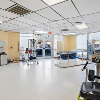 A modern physical therapy clinic with various rehabilitation equipment.
