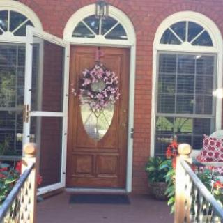 A charming entrance with a decorative wreath, inviting you into a cozy home.