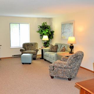 A cozy living room with comfortable seating and warm lighting.