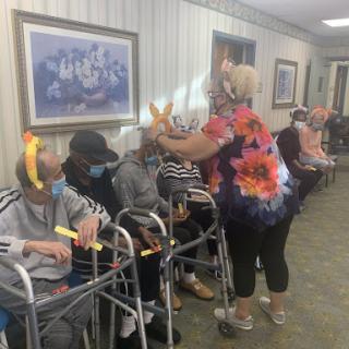 Residents enjoying a lively activity with staff at a care facility.
