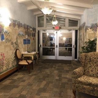 A cozy lobby with decorative murals and comfortable seating.