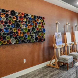 A vibrant art studio with easels and colorful wall art, ready for creative projects.