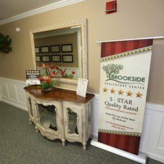 A reception area featuring a banner and award display on a vintage console table.