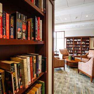 A cozy library with bookshelves and a comfortable reading area.