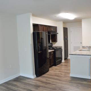 A modern kitchen featuring black appliances and a spacious layout.