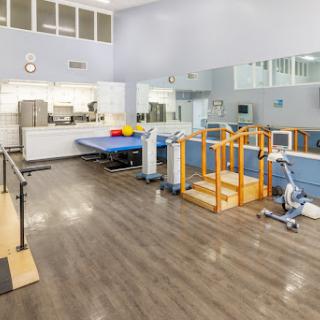 A well-equipped physical therapy gym featuring various exercise apparatus.