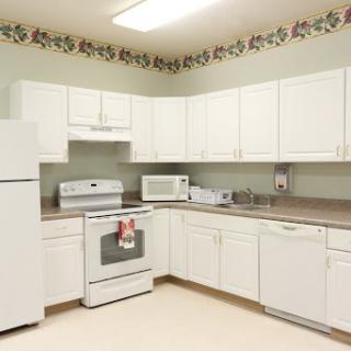 A well-equipped kitchen featuring white cabinetry and modern appliances.