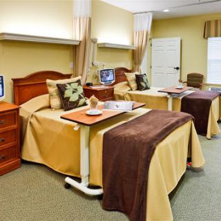 A well-equipped hospital room featuring two patient beds, designed for comfort and convenience.