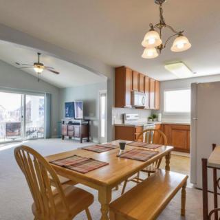 A bright and open dining area adjacent to a cozy kitchen with wooden furniture.