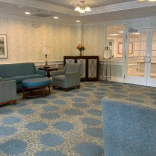 A comfortable and well-decorated waiting area with sofas and armchairs.
