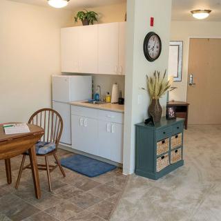 A cozy kitchen and dining area with wooden furniture and simple decor.