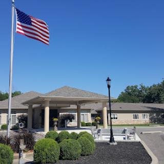 A beautiful day outside a residential building, proudly displaying the American flag.