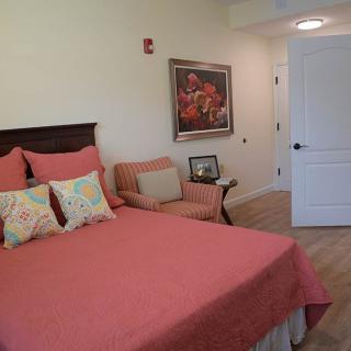 A cozy bedroom with warm-toned bedding and decor.