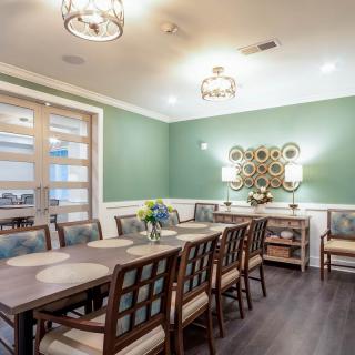 A modern dining room with elegant furniture and soft lighting.