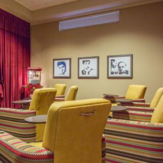 A cozy cinema room with comfortable seating and a classic decor.