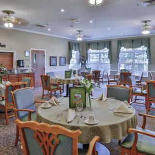 An elegantly designed dining room with neatly arranged tables and chairs.