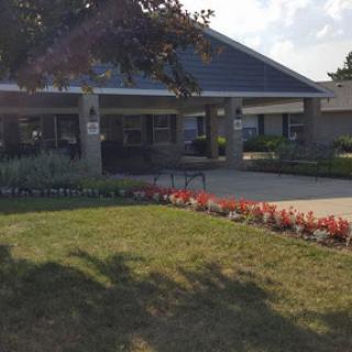 A bright and inviting community center surrounded by colorful flowers.