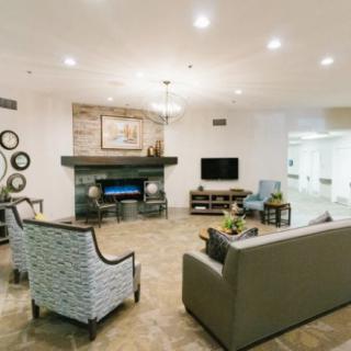 A stylish living room with modern decor, featuring a fireplace and comfortable seating.