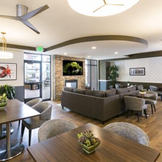 A modern lounge area featuring comfortable seating, stylish decor, and a television.