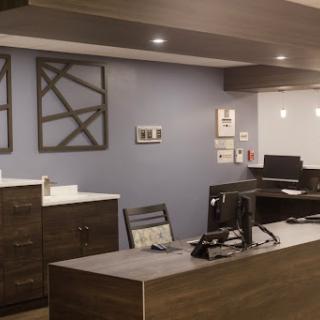 A modern office reception area featuring sleek furniture and a professional atmosphere.