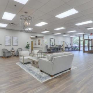 A modern waiting room with comfortable seating and bright lighting.