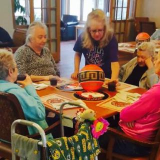 A group of seniors enjoying a social activity together at a table.