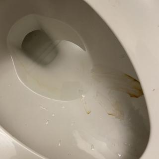 A toilet with visible stains on the bowl.