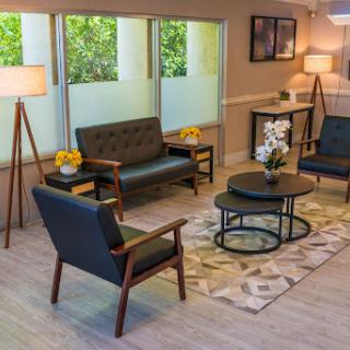 A stylish and inviting living room area featuring cozy seating, modern furniture, and ample natural light.