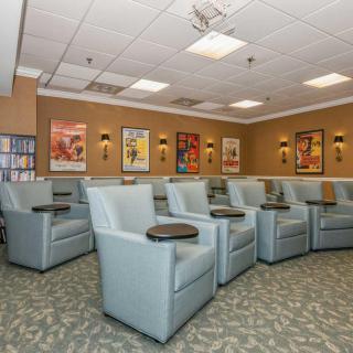 A well-organized waiting room with comfortable seating and decorative posters on the walls.