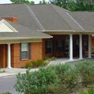 A cozy residential building featuring brick architecture and a well-maintained landscape.
