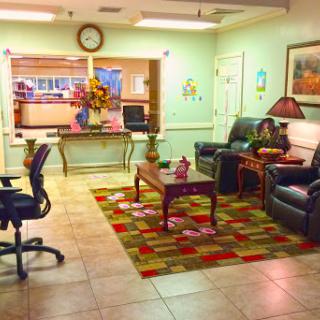A cozy waiting room featuring comfortable seating, a decorative rug, and a welcoming atmosphere.