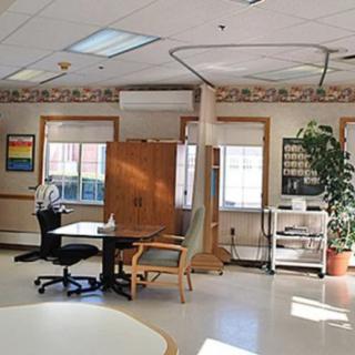 A hospital room with medical equipment and furniture.