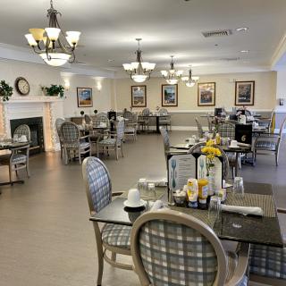 A traditional dining room setup with neatly arranged tables and chairs.
